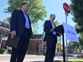 Queen's University principal Daniel Woolf, left, and Kingston Mayor Bryan Paterson announce a pilot project meant to curb uncontrolled student partying in Kingston/