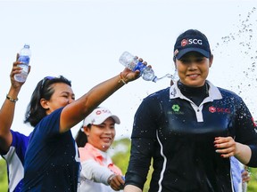 Ariya Jutanugarn, of Thailand, is doused with water by friends and family after winning the final round of the U.S. Women's Open golf tournament at Shoal Creek, Sunday, June 3, 2018, in Birmingham, Ala.