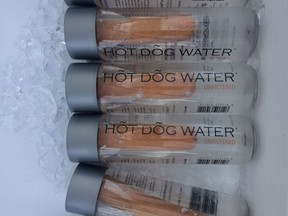 Bottles of Hot Dog Water being sold at an event in Vancouver last week are shown in a handout photo. Douglas Bevans put boiled hot dog water in bottles containing a hot dog and advertised it as providing health benefits, backed up by supposed science.
