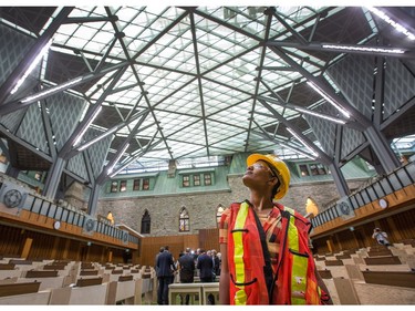 Construction cleaner Tigest Asefa gets a look at the new House of Commons as the media gets a tour of the West Block on Parliament Hill to observe the construction as it begins to near the end and Members of Parliament will begin sitting in the new House of Commons sometime in January 2019. Photo by Wayne Cuddington/ Postmedia