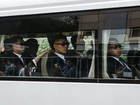 A bus carrying the North Korean security delegation leaves the St. Regis Hotel where North Korean leader Kim Jong Un is staying in Singapore, Monday, June 11, 2018, ahead of the summit between Kim and U.S. President Donald Trump.