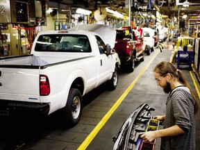 A worker assembles a Ford Motor Co. Super Duty series pickup truck at the company's truck manufacturing plant in Louisville, Kentucky, U.S., on Tuesday, Dec. 1, 2015.