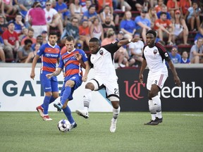 Corben Bone of FC Cincinnati, left, contests the ball with Jamar Dixon of Ottawa Fury FC during a United Soccer League match at Cincinnati on June 30, 2018.