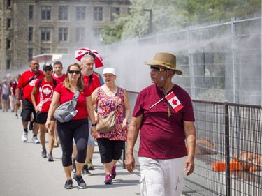 Canada Day celebrations took over the downtown core of Ottawa Sunday July 1, 2018. A mist was cooling down  people as they arrived onto Parliament Hill as they walked up beside west block.