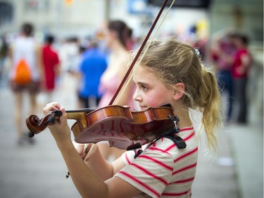 Layla-Bjorn Taherzadeh will celebrate her 10th birthday Monday with a little extra money in her pocket after drawing a crowd to her busking performance on Canada Day.   Ashley Fraser/Postmedia