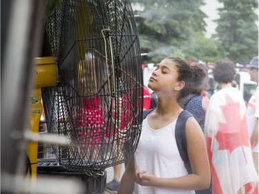 A fan blowing cool water in Majors Hill Park was a big hit on Sunday.   Ashley Fraser/Postmedia