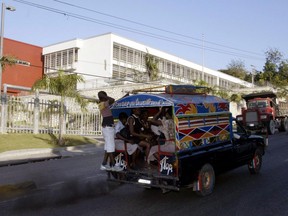 A local passenger bus passes the Canadian Embassy in Port-au-Prince Haiti.