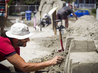 Martin Ernst works on his sand sculpture Saturday.