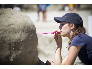 Thirteen-year-old Jasmine Meunier works on her sand sculpture Saturday. This marks the sixth year she has been part of the competition.