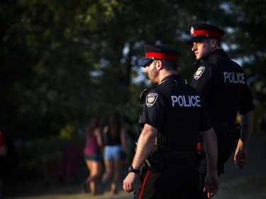 Two Ottawa police officers walked through the ground of RBC Bluesfest as the sun set Sunday July 8, 2018.