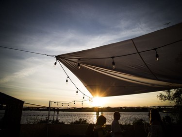 The sun set over the Ottawa River Sunday July 8, 2018, as people enjoyed it from RBC Bluesfest.