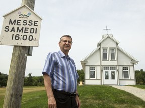 Richard Hotte, president of the Catholic church in Saint-Sixte, stands outside the village's newly built church.