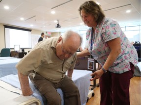 Personal Support Worker Valerie Little assists George Vuillard at the Perley and Rideau Veteran's Health Centre in Ottawa. PSWs themselves need more support.