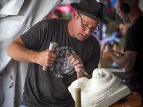 Danny Barber works away on his carving during the 2018 Canadian Stone Carving Festival that was taking place on Sparks Street on Saturday July 21, 2018.
