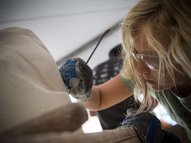 11-year-old Roxanne Maquet works away on her carving during the 2018 Canadian Stone Carving Festival that was taking place on Sparks Street Saturday July 21, 2018.