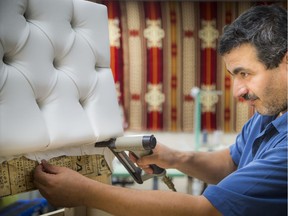 Wael Aun, a Syrian refugee who is one of the first to open his own business, a furniture upholstery business.   Ashley Fraser/Postmedia