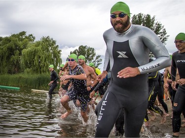 The 37th Annual National Capital Triathlon took place Saturday July 28, 2018 at Mooney's Bay and the surrounding area. Men start the swim portion of the Sprint Triathlon Saturday.  Ashley Fraser/Postmedia