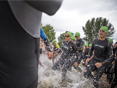 The 37th Annual National Capital Triathlon took place Saturday July 28, 2018 at Mooney's Bay and the surrounding area. Men start the swim portion of the Sprint Triathlon Saturday.  Ashley Fraser/Postmedia