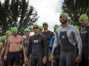 The 37th Annual National Capital Triathlon took place Saturday July 28, 2018 at Mooney's Bay and the surrounding area. Men line up on the start line of the swim of the Sprint Triathlon Saturday.  Ashley Fraser/Postmedia
