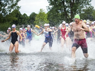 The 37th Annual National Capital Triathlon took place Saturday July 28, 2018 at Mooney's Bay and the surrounding area. Competitors make their way into the water during the Sprint Triathlon Saturday.   Ashley Fraser/Postmedia