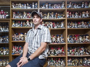 Phil Darling with some of his collection of nearly 3,000 unique bobblehead dolls, a Guinness World Record.