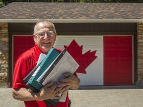 Bob Harper stands outside his home holding just a tiny fraction of the research he's done on Canada's flag. The Brockville resident spent 15,000 hours and close to $250,000 over seven years as he researched and wrote what he says is the definitive, factually accurate account of the story of the flag.