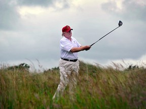 (FILES) This file photo taken on July 10, 2012 shows Donald Trump playing a stroke as he officially opens his new multi-million pound Trump International Golf Links course in Aberdeenshire, Scotland.