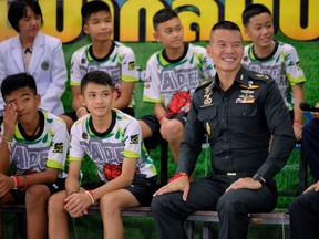 Twelve boys from the "Wild Boars" soccer team and a Thai Navy SEAL (Right) speak during a press conference for the first time since they were rescued from a cave in northern Thailand last week, on July 18, 2018 in Chiang Rai, Thailand. The 12 boys, aged 11 to 16, and their 25-year-old coach were discharged early from Chiang Rai Prachanukroh hospital after a speedy recovery and thanked those involved in their rescue.