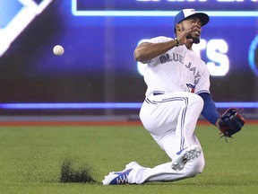 Teoscar Hernandez #37 of the Toronto Blue Jays misplays a ball off the bat of Eduardo Escobar  of the Minnesota Twins that went for a triple in the first inning during MLB game action at Rogers Centre on July 23, 2018 in Toronto.