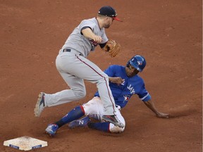 Curtis Granderson #28 of the Toronto Blue Jays is forced out at second base by Brian Dozier #2 of the Minnesota Twins but Dozier cannot turn the double play in the eleventh inning during MLB game action at Rogers Centre on July 25, 2018 in Toronto.