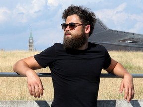 With Parliament Hill in the background, Mike Rosenberg - otherwise known as Passenger - stands atop the Canadian War Museum in Ottawa ahead of his gig on opening night of Bluesfest Thursday (July 5, 2018). Julie Oliver/Postmedia