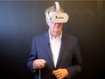 Ottawa mayor Jim Watson uses virtual reality goggles to tour a home at Umber Realty Wednesday (July 4, 2018). VR technology to show homes to prospective buyers is the future, says Umber founder Shaun Denis.  Julie Oliver/Postmedia