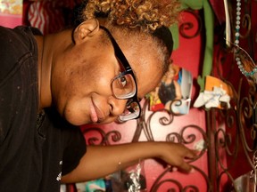 Oni Joseph, known as the Haitian Sensation, points to the spot where the bullet came through the wall.