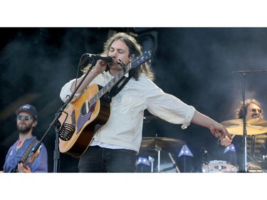 War on Drugs lead singer and guitarist Adam Granduciel  wails on the harmonica.