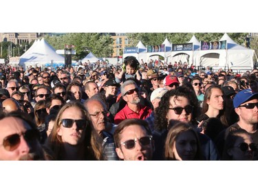 A girl perched on her dad's shoulders seemed slightly indifferent to the music as she clapped her hands over her headphones while the bass was turned up on the War on Drugs show.