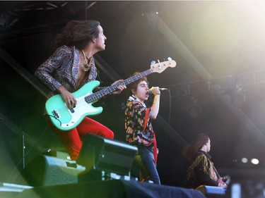 Josh Kiszka (M), bassist Sam Kiszka (L) and guitarist Jake Kiszka (R) of Greta Van Fleet perform at the RBC Ottawa Bluesfest, July 10, 2018.