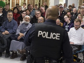 In this file photo, Ottawa Police Service Constable Kevin Williams addresses a crowd at a Bells Corners neighbourhood watch information session.