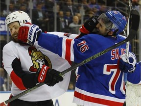 Zack Smith and Brady Skjei of the New York Rangers battle during the first period in Game Four of the Eastern Conference Second Round during the 2017 NHL Stanley Cup Playoffs.