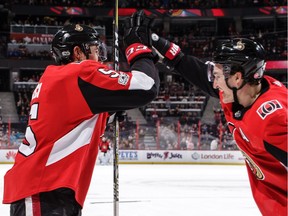 Cody Ceci, left, celebrates his second-period goal against the Rangers with Mark Stone in a game at Canadian Tire Centre on Dec. 13, 2017.