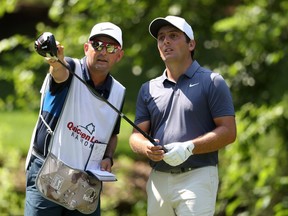 Francesco Molinari, right, consults with his caddy before hitting a shot on the seventh tee during the final round of the Quicken Loans National on Sunday.