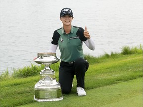 Sung Hyun Park of South Korea celebrates with the trophy after winning the KPMG Women's PGA Championship at Kildeer, Ill., on Sunday.