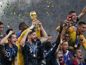 Hugo Lloris of France lifts the World Cup trophy to celebrate with his teammates after the 2018 FIFA World Cup Final between France and Croatia at Luzhniki Stadium on July 15, 2018 in Moscow, Russia.