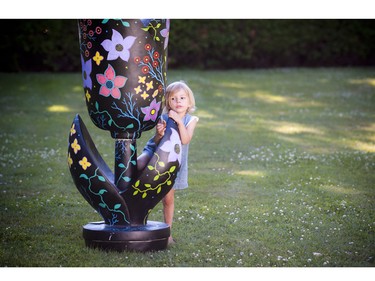 Three-year-old Emilie Hagluand played around the tulip that was painted by Trevor Sylvain.