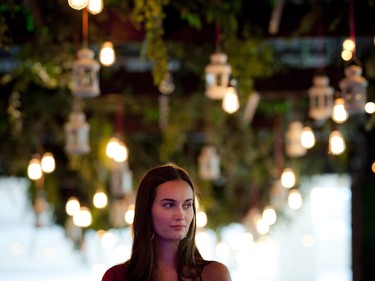 A model from Angie's AMTI standing on a pedestal overlooking the party.