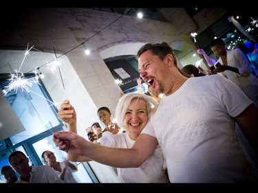 Alpha Art Gallery owner and director Edith Betkowski and her partner, artist Dominik Sokolowski, playing with sparklers.