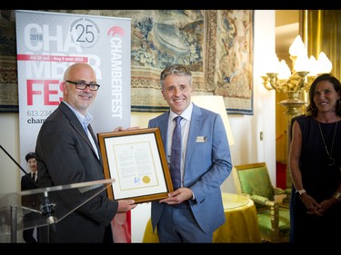 Ottawa Coun. Jeff Leiper (left) presents a framed Chamberfest Day proclamation to Roman Borys, Ottawa Chamberfest artistic and executive director.