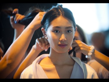 14-year-old Emily Zhou, a model with Angie's Models & Talent International, gets her hair done before she walks the runway.