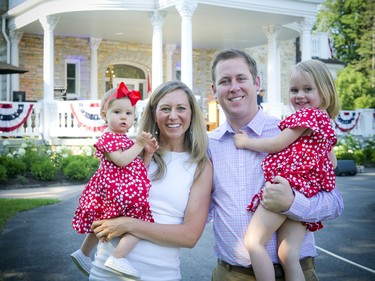 Joseph Craft's son Ryan holding his daughter, three-year-old Elizabeth, with his wife Lauren holding their other daughter, 14-month-old Lucy.
