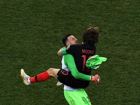 Croatian goalkeeper Danijel Subasic, left, celebrate with midfielder Luka Modric after clinching victory against Denmark at Nizhny Novgorod Stadium on Sunday.