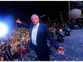 TOPSHOT - Newly elected Mexico's President Andres Manuel Lopez Obrador, running for "Juntos haremos historia" party, cheers his supporters at the Zocalo Square after winning general elections, in Mexico City, on July 1, 2018.